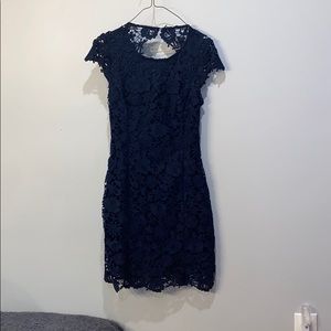 Lulus Blue body con dress with open back.